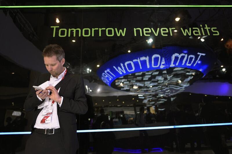 A visitor tests a phone during the opening day of the 2015 Mobile World Congress. AFP
