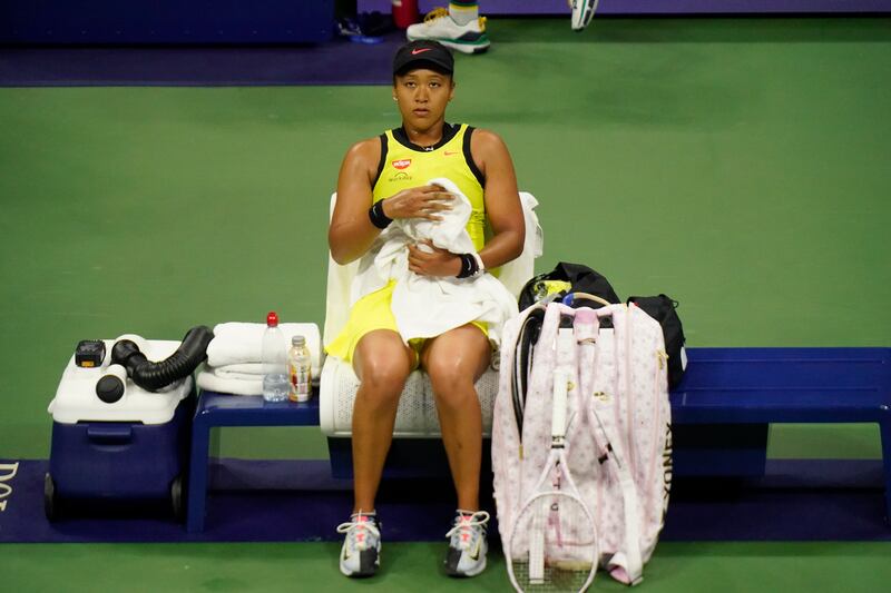 Naomi Osaka, of Japan, sits on the bench between games against Leylah Fernandez, of Canada, at the third round of the US Open tennis championships.  AP