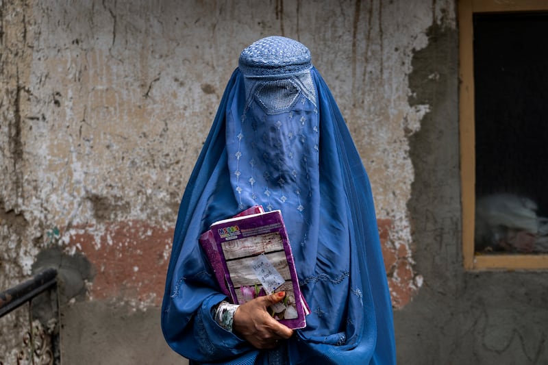 An Afghan woman leaves an underground school in Kabul. Millions of women had rights taken away when the Taliban returned to power two years ago. AP