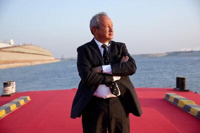 Egyptian billionaire Naguib Sawiris poses for a photograph on a floating pontoon in front of the New Suez Canal, operated by the Suez Canal Authority, in Ismailia, Egypt, on Thursday, Aug. 6, 2015. The expansion will meet future demand, with traffic expected to double to 97 vessels a day by 2023, said Mohab Mameesh, head of the Suez Canal Authority. Photographer: Shawn Baldwin/Bloomberg *** Local Caption *** Naguib Sawiris