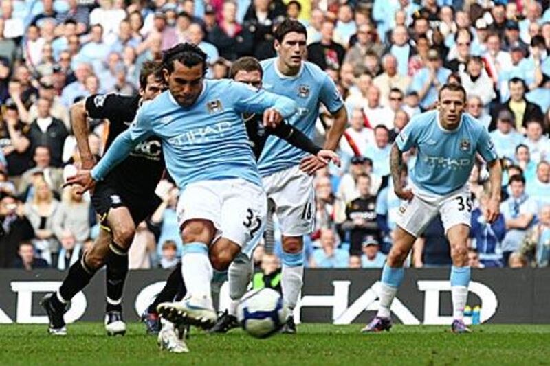 Carlos Tevez opens Manchester City's scoring rout against Birmingham City from the penalty spot.