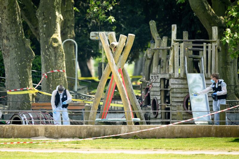 Police officers work inside a cordoned-off area at the site of the attack. EPA