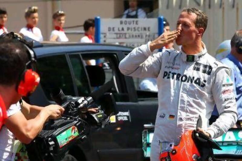 Michael Schumacher greets the crowds after he clocked the fastest time in qualifying for the Monaco Grand Prix. Jens Buettner / EPA