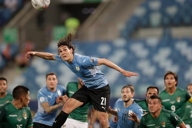 Edinson Cavani heads the ball during the Copa America match against Bolivia. AP