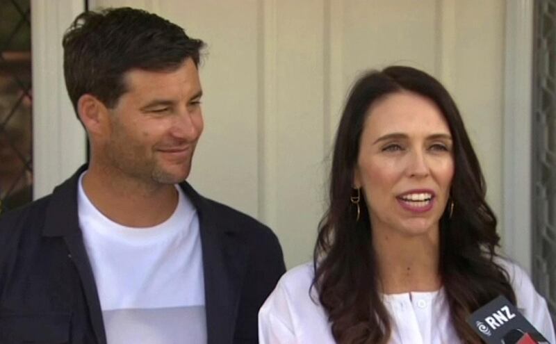 In this image made from a video, New Zealand's Prime Minister Jacinda Ardern, right, with her partner Clarke Gayford speaks to journalists in front of home in Auckland, New Zealand Friday, Jan. 19, 2018. Ardern announced on Friday that she is expecting her first child in June. (TVNZ via AP)