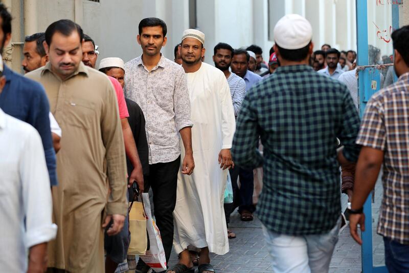 Dubai, United Arab Emirates - May 16, 2019: People wait for Iftar food. Mosque series for Ramdan. Lootah Masjid Mosque is an old mosque in Deira. Thursday the 16th of May 2019. Deira, Dubai. Chris Whiteoak / The National