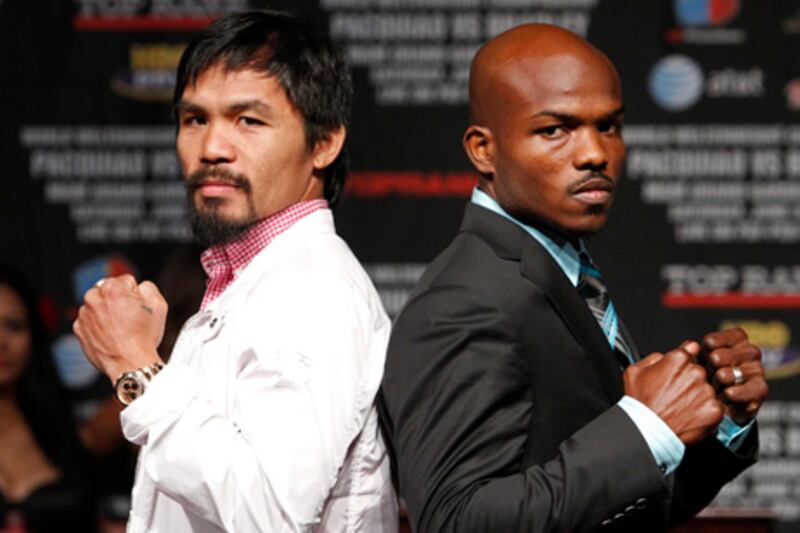 Manny Pacquiao, left, and Timothy Bradley pose for photographers during a press conference at the MGM Grand in Las Vegas Wednesday, June 6, 2012. The two will fight for the WBO World Welterweight title Saturday. (AP Photo/Las Vegas Review-Journal, John Locher)