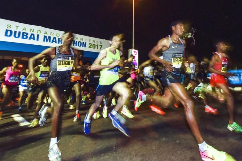 The Dubai Marathon course is perhaps unique in allowing participants to race alongside elite runners. AFP