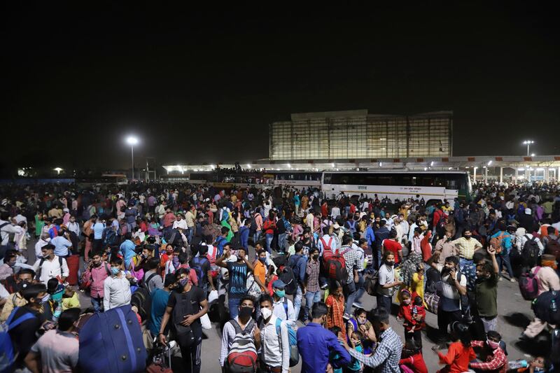 Indian migrant workers wait for buses to leave New Delhi. AP Photo