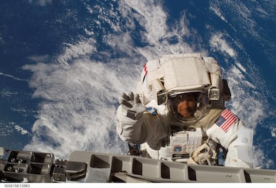 An astronaut wearing Nasa's Extravehicular Mobility Unit carries out repairs in space. Courtesy: Nasa