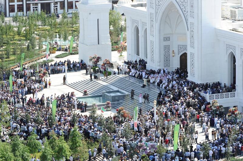 People gather outside a new mosque.