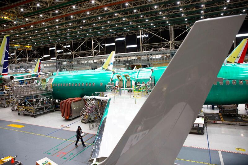 (FILES) In this file photo taken on March 27, 2019, employees work on Boeing 737 MAX airplanes at the Boeing Renton Factory in Renton, Washington. May 27, 2020 Boeing says production of embattled 737 MAX has resumed. / AFP / Jason Redmond
