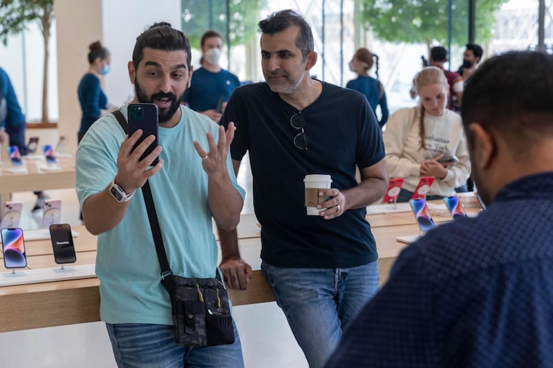 The first customers through the doors of Apple's flagship Dubai Mall store get their hands on the new iPhone 14. All photos by Antonie Robertson / The National