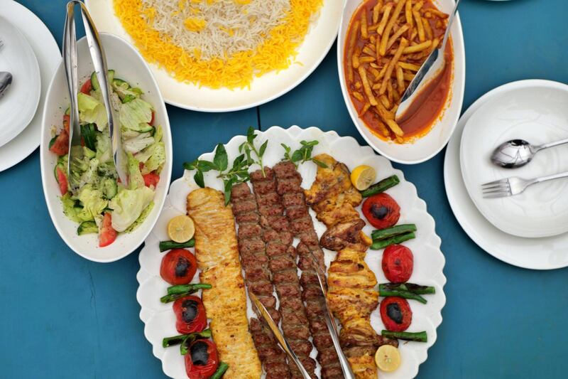 Pictured: A selection of Iranian-inspired dishes served at Taj Begum, owned by Laila Haidari. The plates offer a selection of chicken and lamb kebabs, salad, fries in a tomato sauce and rice.
Photo by Charlie Faulkner