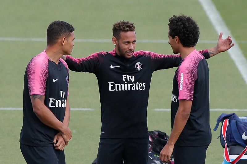 Paris Saint-Germain's Neymar, centre, talks with Thiago Silva, left, and Marquinhos during a training session in Paris. AP Photo