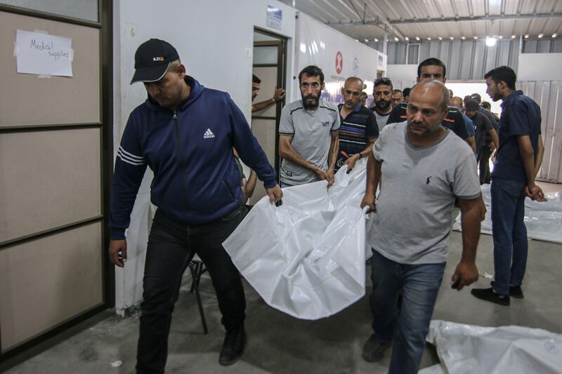 The bodies of those killed during an Israeli strike on a camp for displaced Palestinians have been taken to the Tal Al Sultan clinic in Rafah. Bloomberg