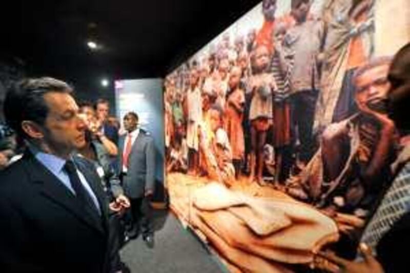 France's President Nicolas Sarkozy visits the Memorial of the Rwandan genocide in Kigali on February 25, 2010. Nicolas Sarkozy on Thursday paid homage to the victims of the genocide against Rwanda's Tutsis during a highly symbolic visit aimed at mending strained relations. "In the name of the people of France, I pay my respects to the victims of the genocide against the Tutsis," he wrote in the visitors book of the main genocide memorial in the capital Kigali. AFP PHOTO - POOL / Philippe Wojazer
