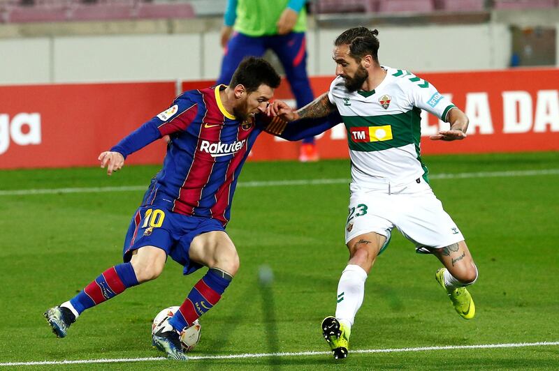 Lionel Messi takes on Elche defender Miguel Angel Garrido Cifuentes. EPA