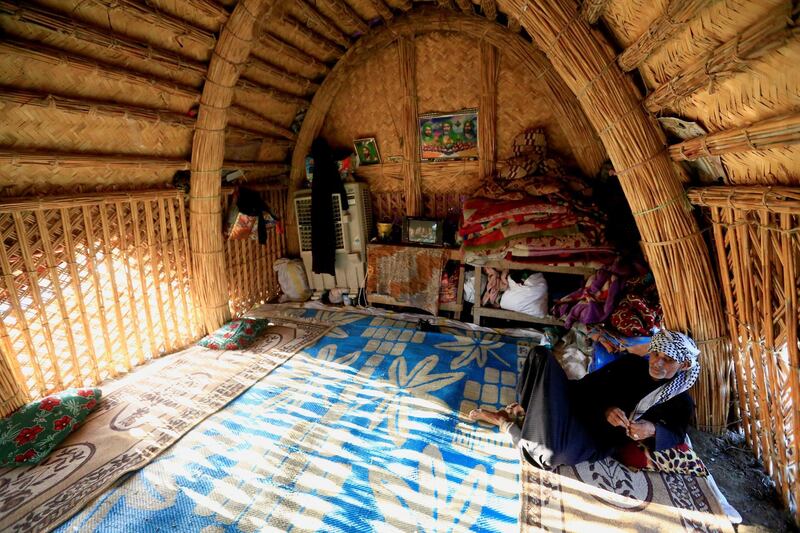 An Iraqi man sits in his house which is made of reeds at the Chebayesh marsh in Dhi Qar province. Reuters