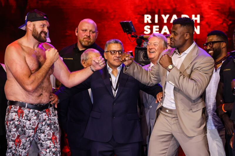 Tyson Fury and Francis Ngannou size each other up in London. PA
