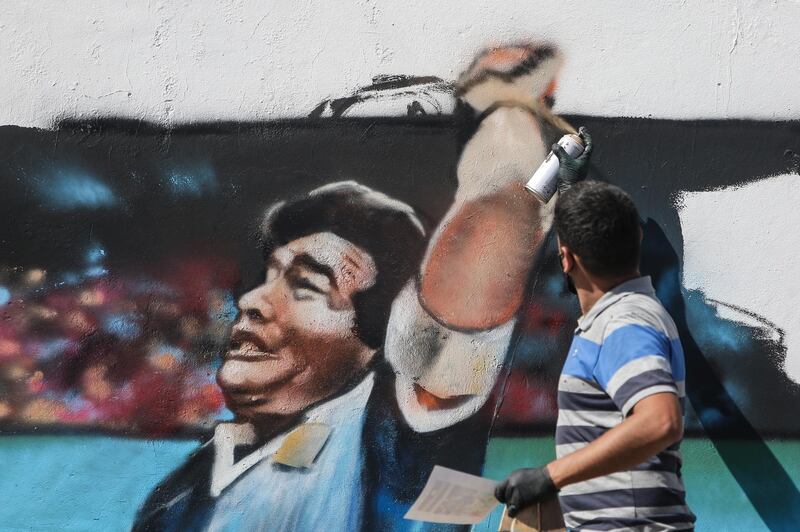 A man paints a mural of Maradona at Villa Palito neigborhood in La Matanza municipality, Buenos Aires. EPA