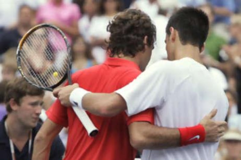 Roger Federer embraces Novak Djokovic after their semi-final clash.