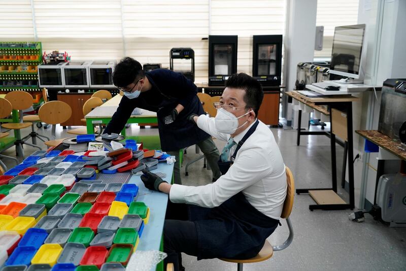 A professor talks with his colleagues as he works at Pusan National University in Busan, South Korea. Reuters