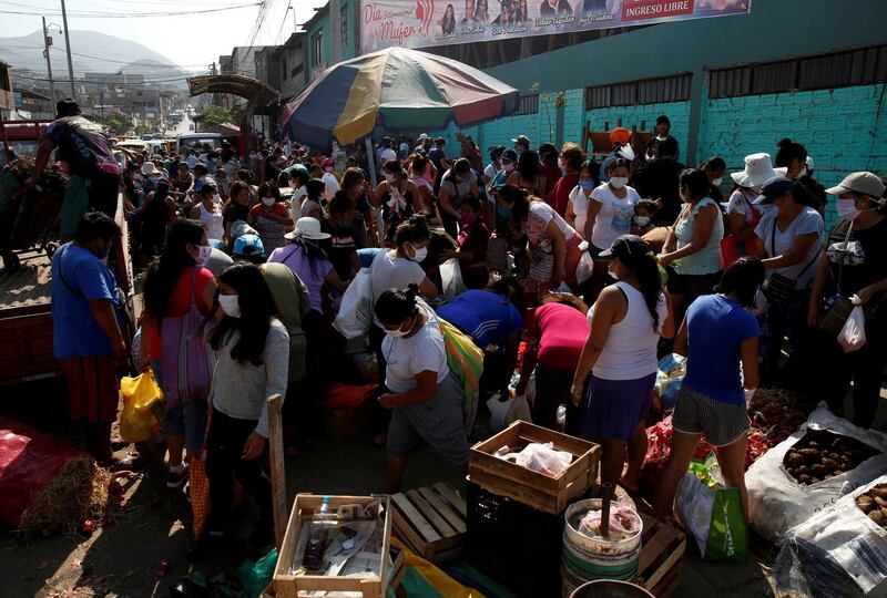 Women shop at a market after the Peruvian government limited men and women to alternate days for leaving their homes, in an attempt to slow the spread of coronavirus, in Lima, Peru. Reuters