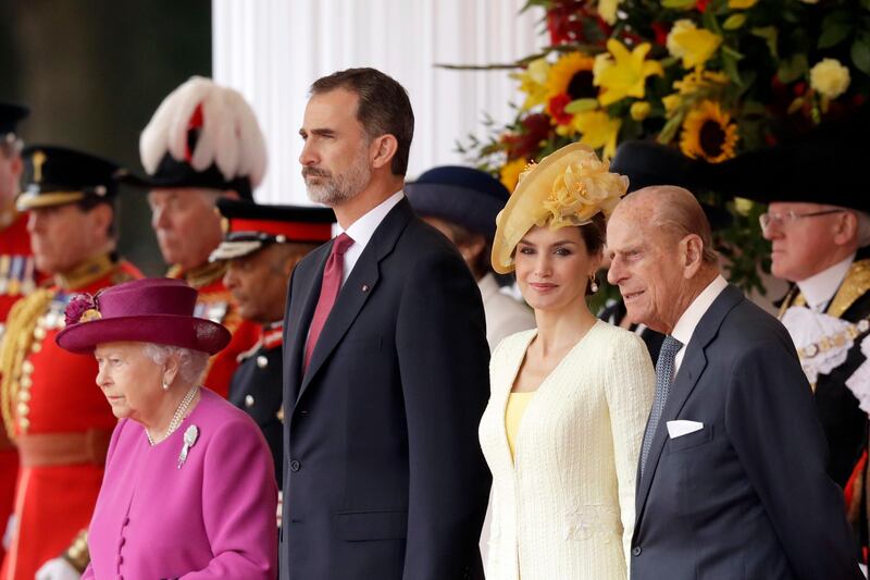 Queen Elizabeth II stands with King Felipe, Queen Letizia, and Prince Philip during a ceremonial welcome in London.