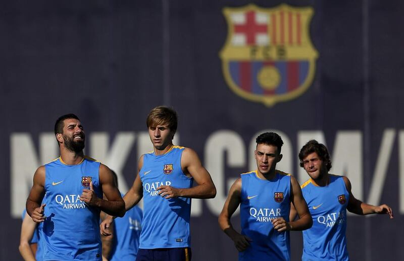 New Barcelona player Arda Turan, left, takes part in training. Josep Lago / AFP / July 13, 2015