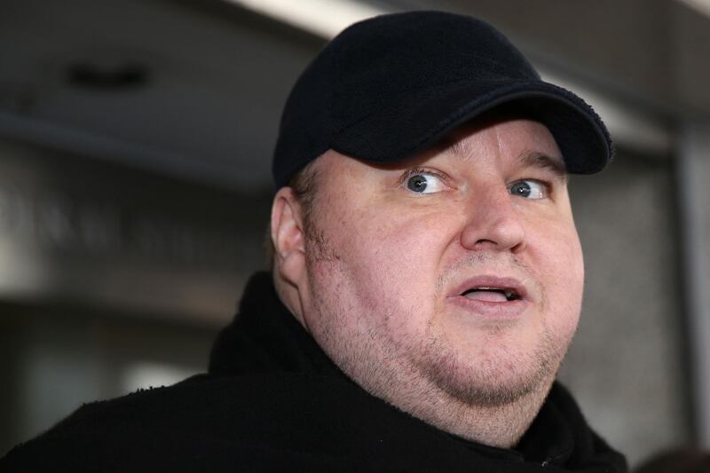 (FILES) In this file photo taken on December 22, 2015, Internet mogul Kim Dotcom leaves an Auckland court after a judge ruled that he and three other defendants are eligible for extradition to the US. New Zealand's Court of Appeal ruled on July 5, 2018, Kim Dotcom was eligible for extradition to the United States, in a major setback for the Internet mogul who is accused of online piracy. / AFP / MICHAEL BRADLEY

