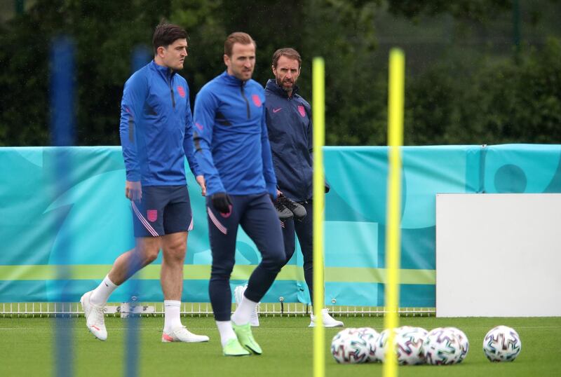 England manager Gareth Southgate with Harry Maguire and Harry Kane during a training session. PA