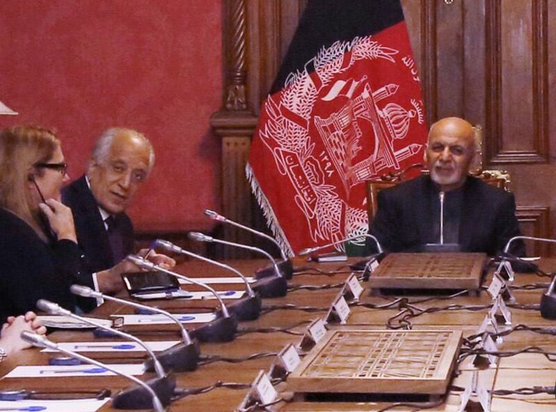 Zalmay Khalilzad (second from left) and Ashraf Ghani (right) were often at odds with one another. Getty