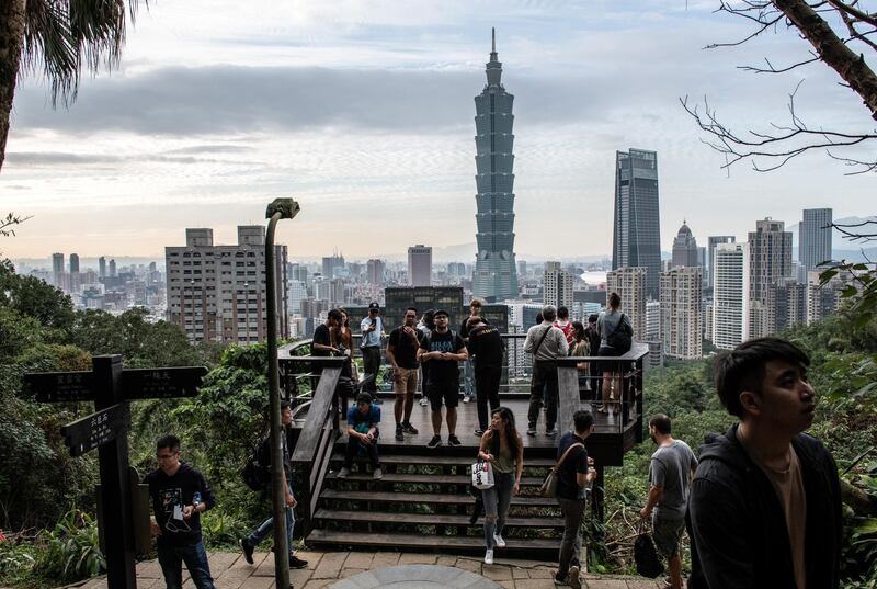 TAIPEI, TAIWAN - JANUARY 07: People enjoy the view of the Taipei 101 tower, once the worlds tallest building, and the Taipei skyline, from the top of Elephant Mountain on January 7, 2020 in Taipei, Taiwan. Taiwanese will go to the polls on Saturday after a campaign in which fake news and the looming shadow of China and its repeated threats of invasion have played a prominent role in shaping debate. Ensuring Taiwans democratic way of life has dominated an election which will be closely fought between incumbent, anti-China president Tsai Ing-wen and the more pro-Beijing challenger Han Kuo-yu. (Photo by Carl Court/Getty Images)