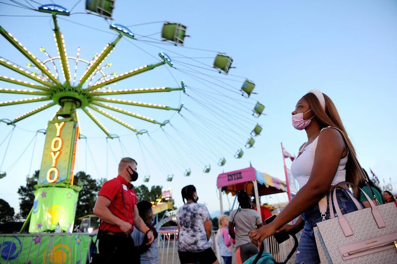 Miyana Moffett watches a ride at the Mississippi State Fair as it opens with coronavirus disease (COVID-19) restrictions in Jackson, Mississippi, U.S. REUTERS