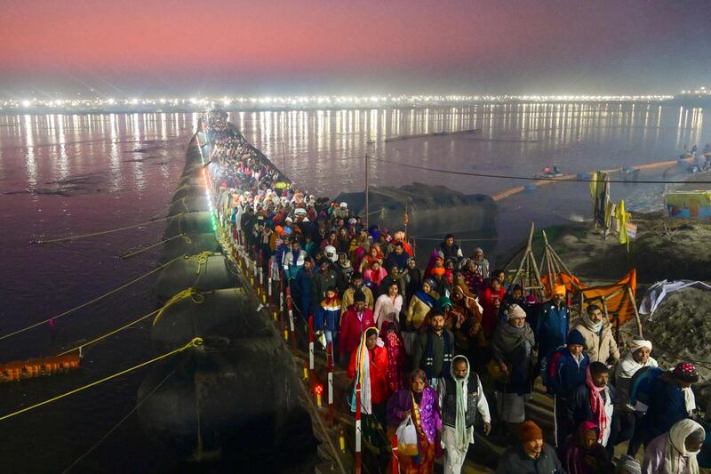Hindu devotees arrive to bathe at the Sangam – the confluence of the rivers Ganges, Yamuna and mythical Saraswati – on the Mauni Amavasya  auspicious day, during the Magh Mela festival in Prayagraj, in Uttar Pradesh, northern India. AFP