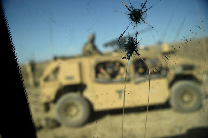 (FILES) In this file photo taken on July 7, 2018, US Army soldiers from NATO are seen through a cracked window of an armed vehicle in a checkpoint during a patrol against Islamic State militants at the Deh Bala district in the eastern province of Nangarhar Province.  The US military claims to have "successfully" disrupted the online propaganda efforts of the Islamic State in a hacking operation dating back at least to 2016, according to declassified national security documents released on January 21, 2020. The heavily redacted, previously top secret documents said the US Cyber Command "successfully contested ISIS in the information domain" and limited its online efforts on radicalization and recruitment "by imposing time and resource costs" on the jihadist group.
 / AFP / WAKIL KOHSAR
