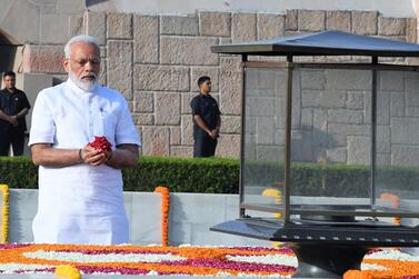 Narendra Modi pays tribute at Mahatma Gandhi's memorial ahead of his swearing-in as the 16th prime minister of India on Thursday. EPA    