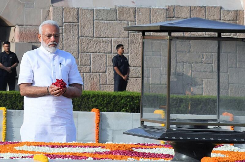 epa07611625 Indian Prime Minister-designate Narendra Modi pays tribute at Mahatma Gandhi's memorial ahead of his swearing-in as the 16th prime minister of India at the Rajghat in New Delhi, India, 30 May 2019. Tight security was being put in place for the swearing-in of Narendra Modi, to be attended by leaders of neighboring countries. Modi retained the position of Prime Minister along with the Bhartya Janta Party (BJP) by earning the massive mandate in Parliamentary elections, which began on 11 April 2019 and was held in seven phases.  EPA/STR