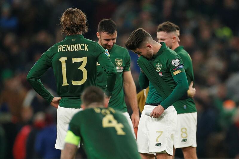 Republic of Ireland players Sean Maguire, Jeff Hendrick and teammates look dejected after the match. Reuters