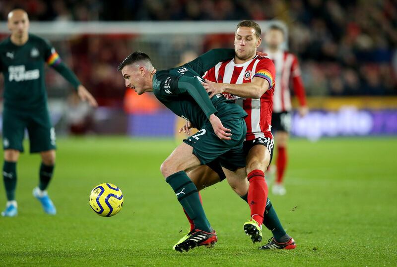SHEFFIELD, ENGLAND - DECEMBER 05: Billy Sharp (R) of Sheffield challenges Ciaran Clark of Newcastle during the Premier League match between Sheffield United and Newcastle United at Bramall Lane on December 05, 2019 in Sheffield, United Kingdom. (Photo by Alex Livesey/Getty Images)