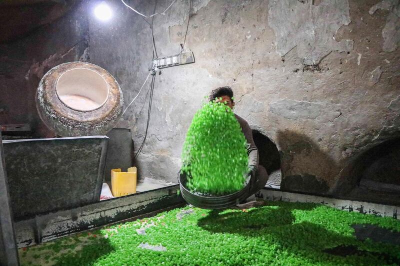 An Afghan worker makes sweets at a factory in Herat, Afghanistan.  EPA