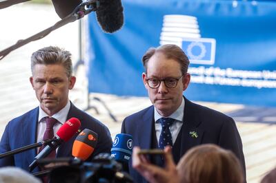Sweden's Defence Minister Pal Jonson, left, and Foreign Minister Tobias Billstrom speak to the media at the start of a European Foreign Affairs Council meeting. EPA