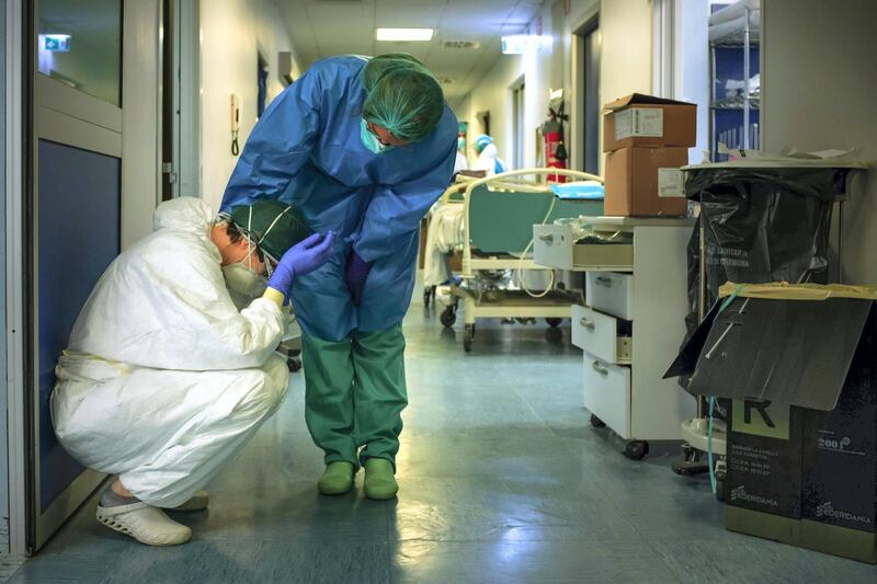 -- AFP PICTURES OF THE YEAR 2020 --

A nurse wearing protective mask and gear comforts another as they change shifts on March 13, 2020 at the Cremona hospital, southeast of Milan, Lombardy, during the country's lockdown aimed at stopping the spread of the COVID-19 (new coronavirus) pandemic. - After weeks of struggle, they're being hailed as heroes. But the Italian healthcare workers are exhausted from their war against the new coronavirus. (Photo by Paolo MIRANDA / AFP) / RESTRICTED TO EDITORIAL USE - MANDATORY CREDIT "AFP PHOTO / PAOLO MIRANDA" - NO MARKETING - NO ADVERTISING CAMPAIGNS - DISTRIBUTED AS A SERVICE TO CLIENTS