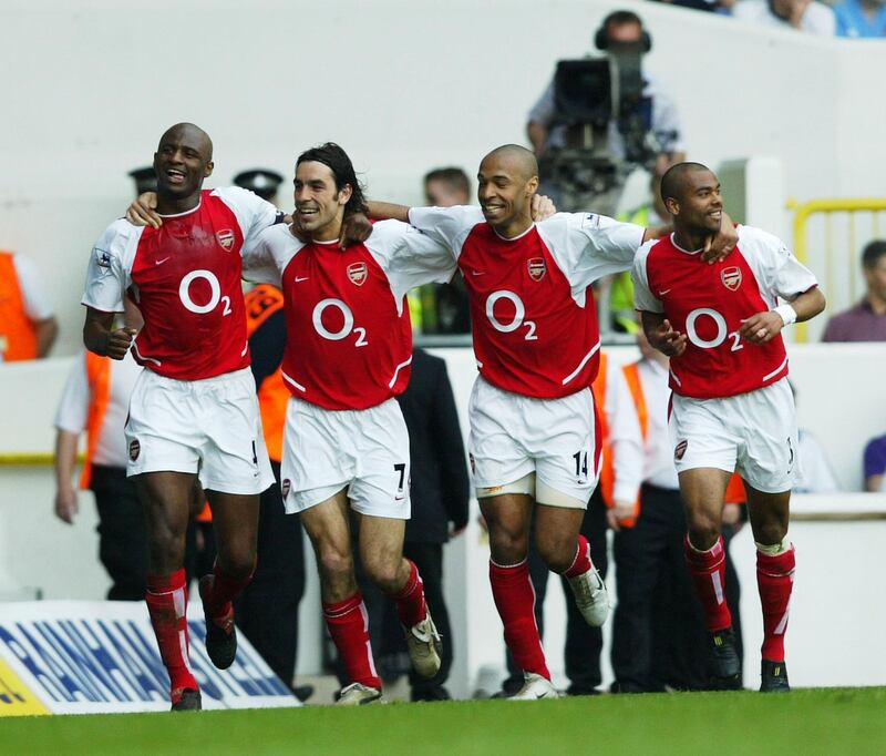 LONDON - APRIL 25: Patrick Vieira, Robert Pires, Thierry Henry and Ashley Cole of Arsenal celebrate after the second goal during the FA Barclaycard Premiership match between Tottenham Hotspur and Arsenal at White Hart Lane on April 25, 2004 in London.  (Photo by Shaun Botterill/Getty Images)