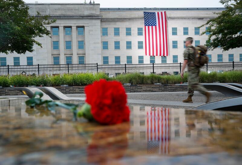 A member of the military walks the grounds of the National 9/11 Pentagon Memorial. AP Photo