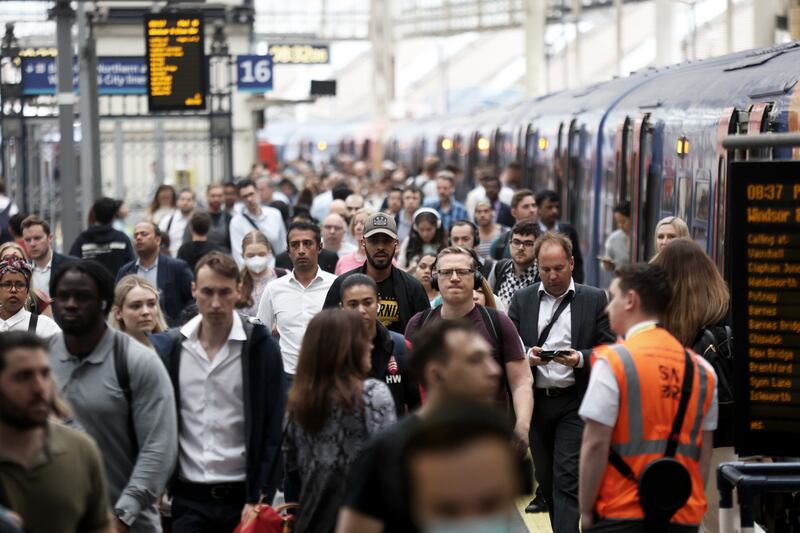 Passengers leaving a train at Waterloo station. PA