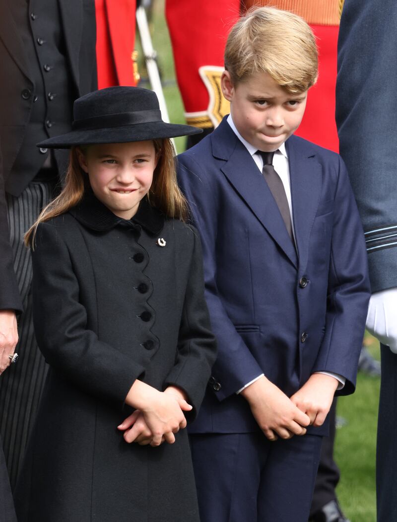 Princess Charlotte wears a horseshoe pin, a nod to the queen's love of horses. PA News