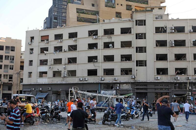 People gather near the scene of the explosion in Beirut.  AFP