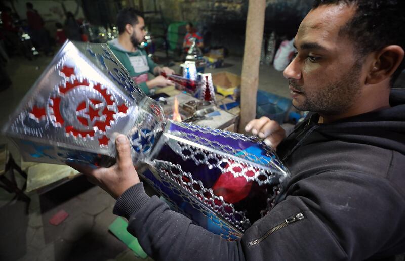 An Egyptian craftsman makes traditional Ramadan lanterns, called Fanous, at a workshop in Cairo, Egypt. EPA